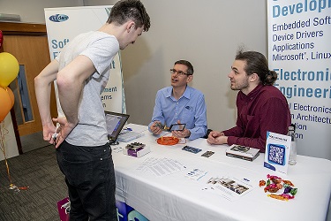 Bruce and Lucas discussing with a student