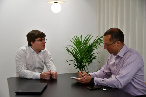 Luke discussing with JonO in meeting room