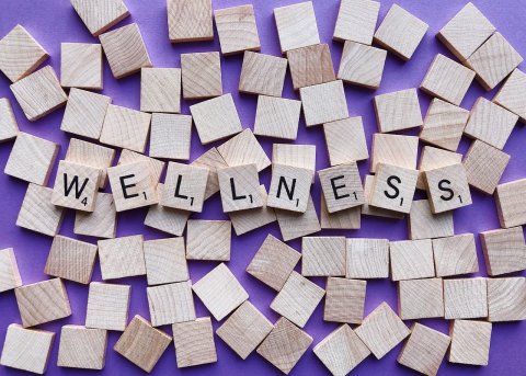 Wooden scrabble tiles spelling out the word wellness