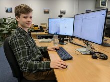 Laurence at his desk in the office